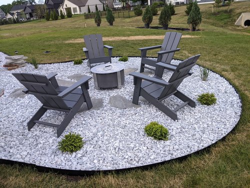 gravel area with firepit and chairs