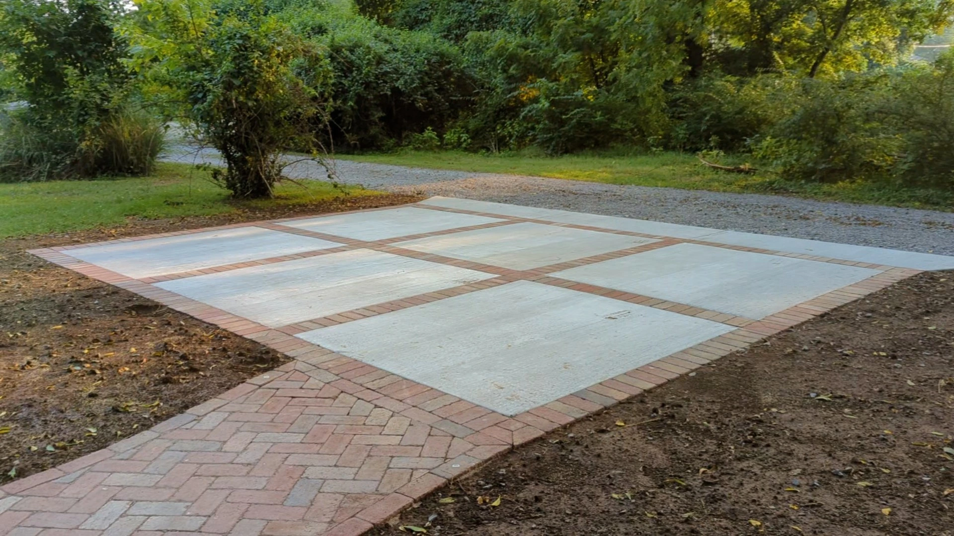 6 large concrete pads lined with small red bricks