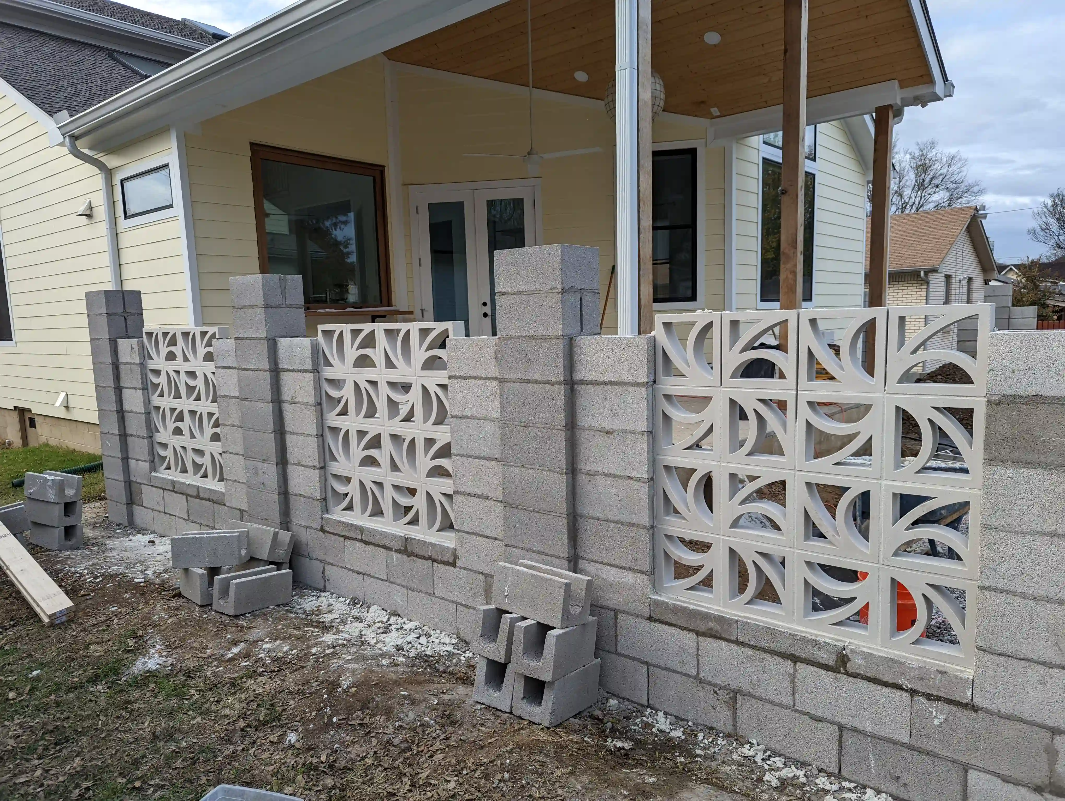 progress picture of a concrete divider wall build. the interior is made with cinderblocks