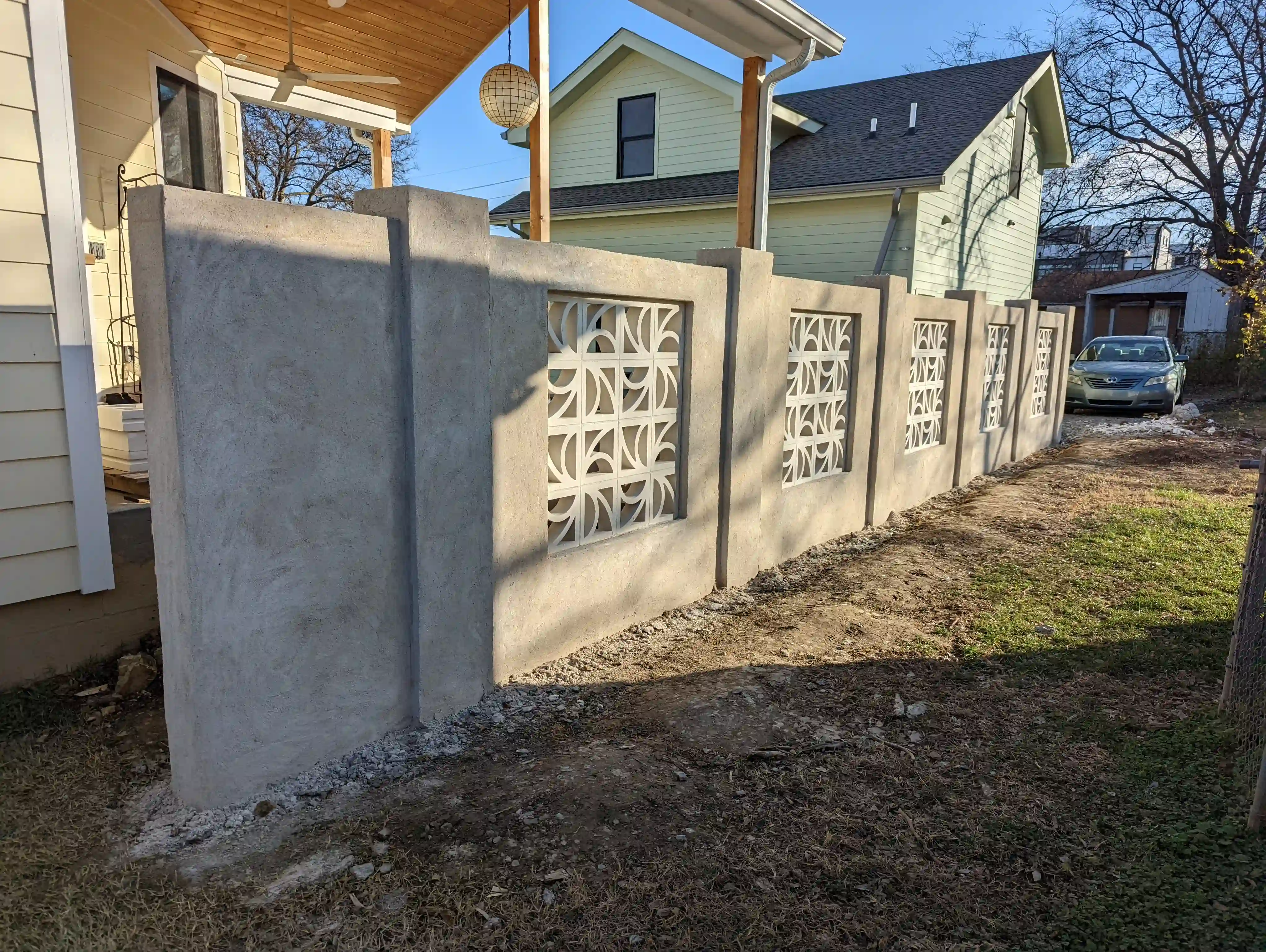 finished concrete divider wall with interesting white geometric stones in the middle of each section