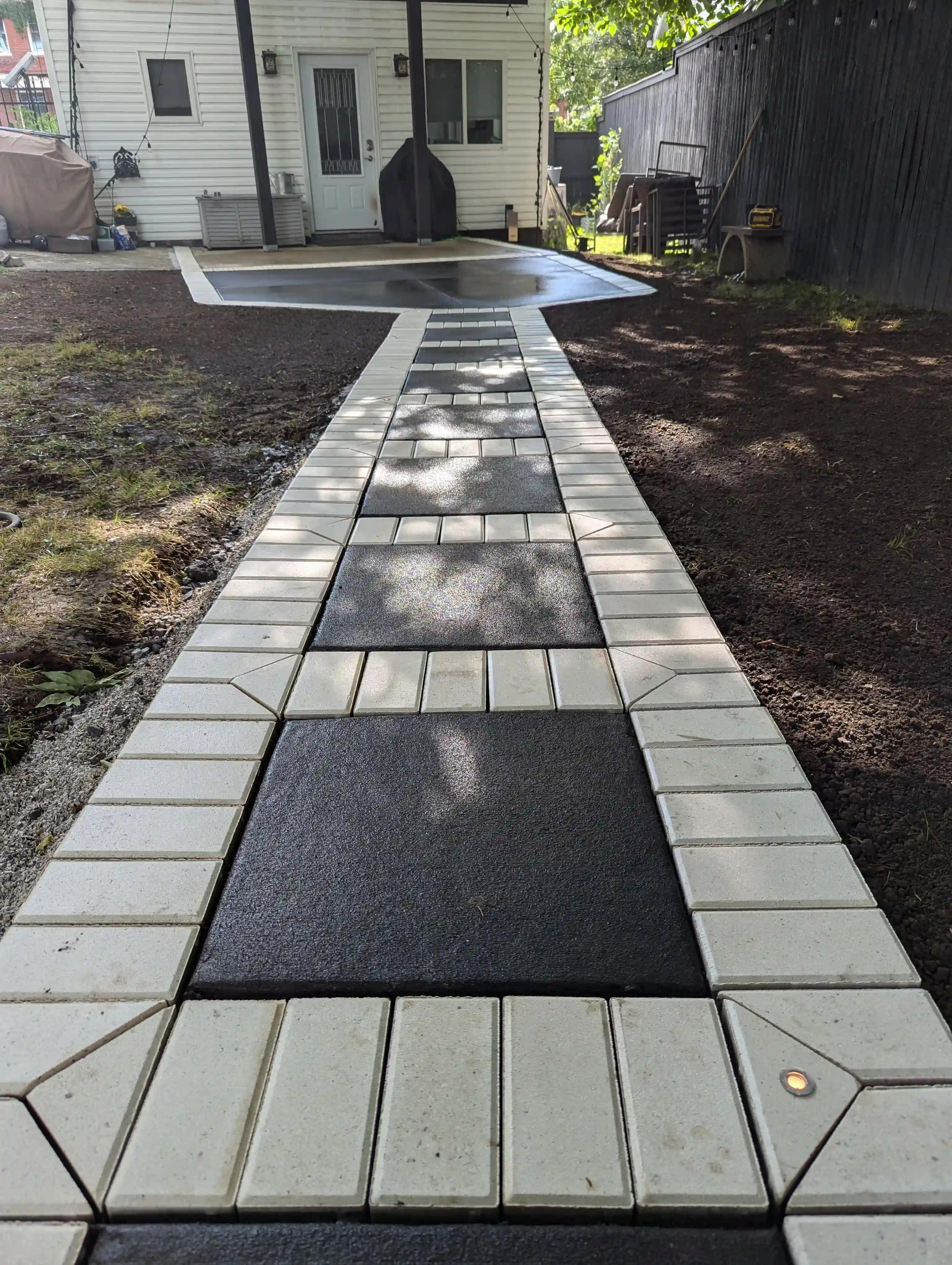large square stepping stones lined with white pavers