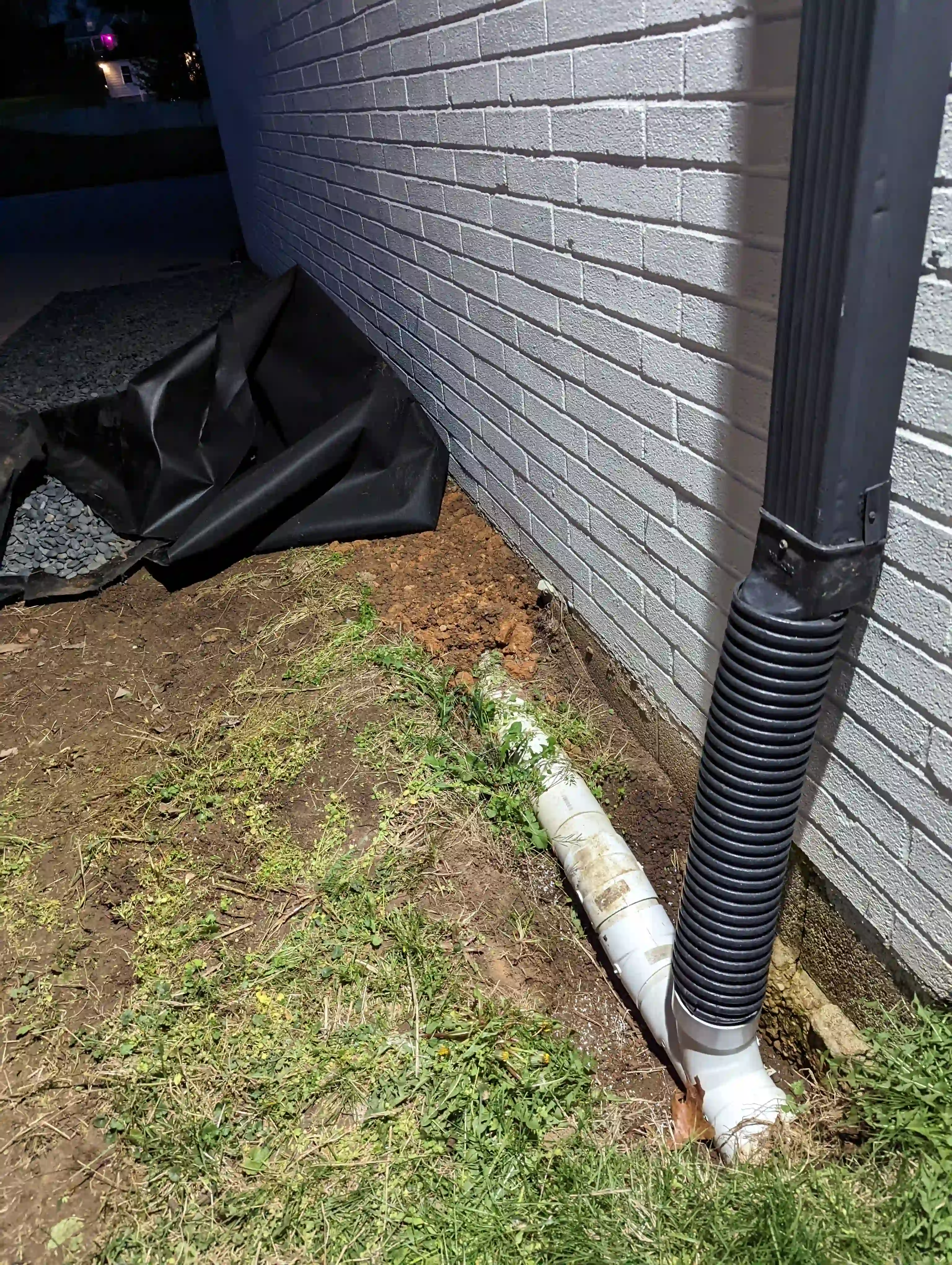 Excavated trench with drainage pipe ready for installation