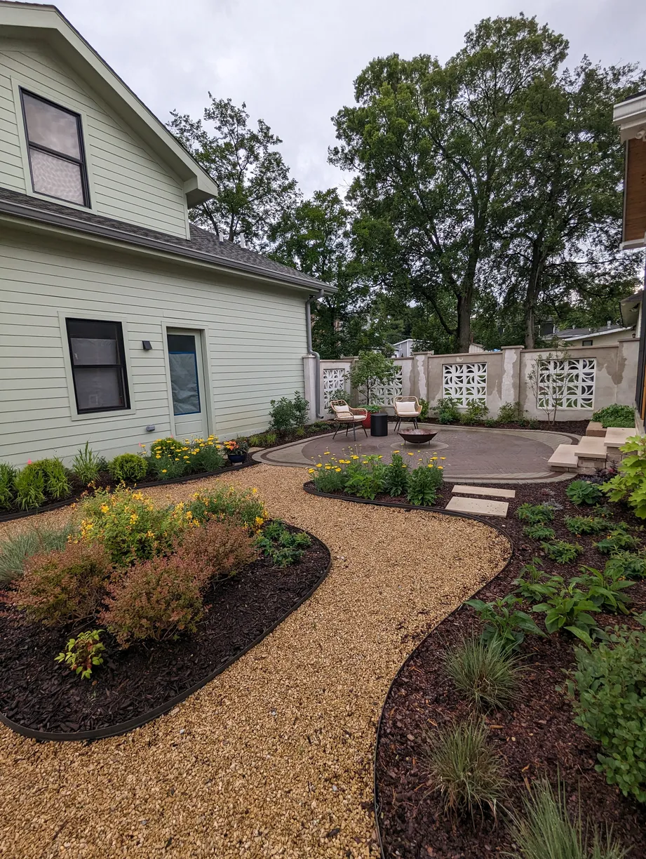 pea gravel walkways lined with garden beds filled with various bushes