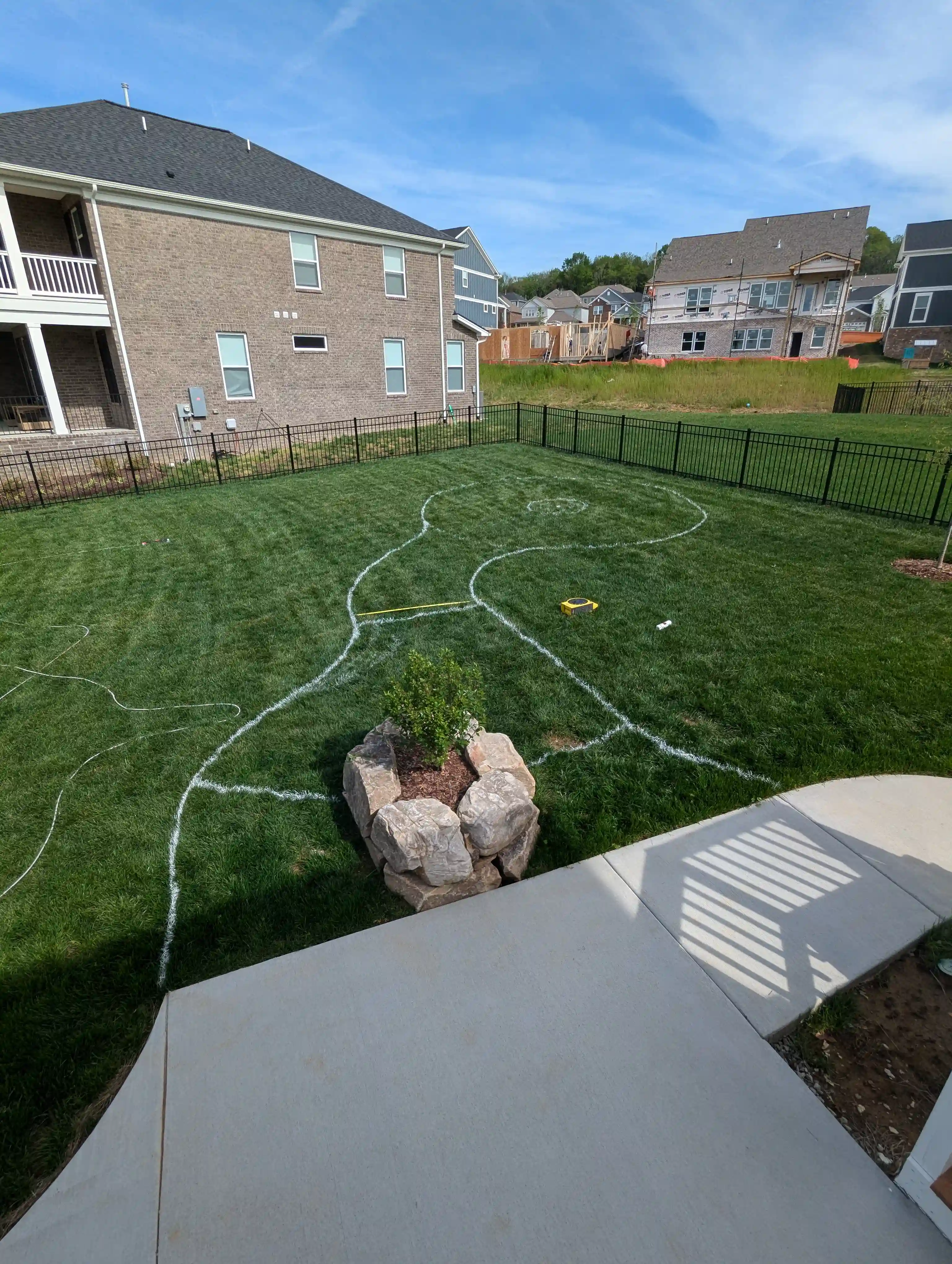 chalk lines in grass indicating an upcoming landscaping plan