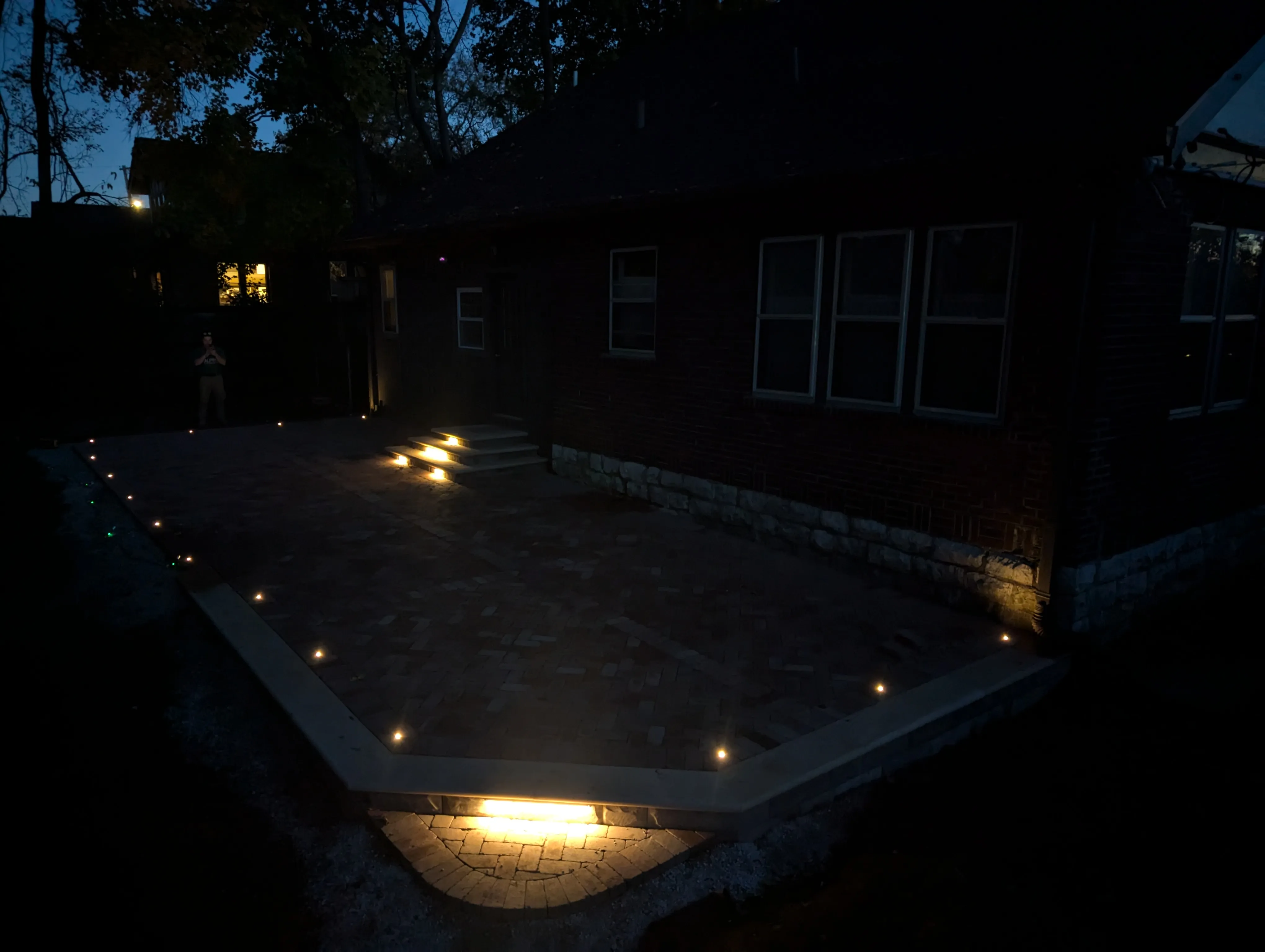 Sophisticated garden lighting creating depth and dimension after sunset