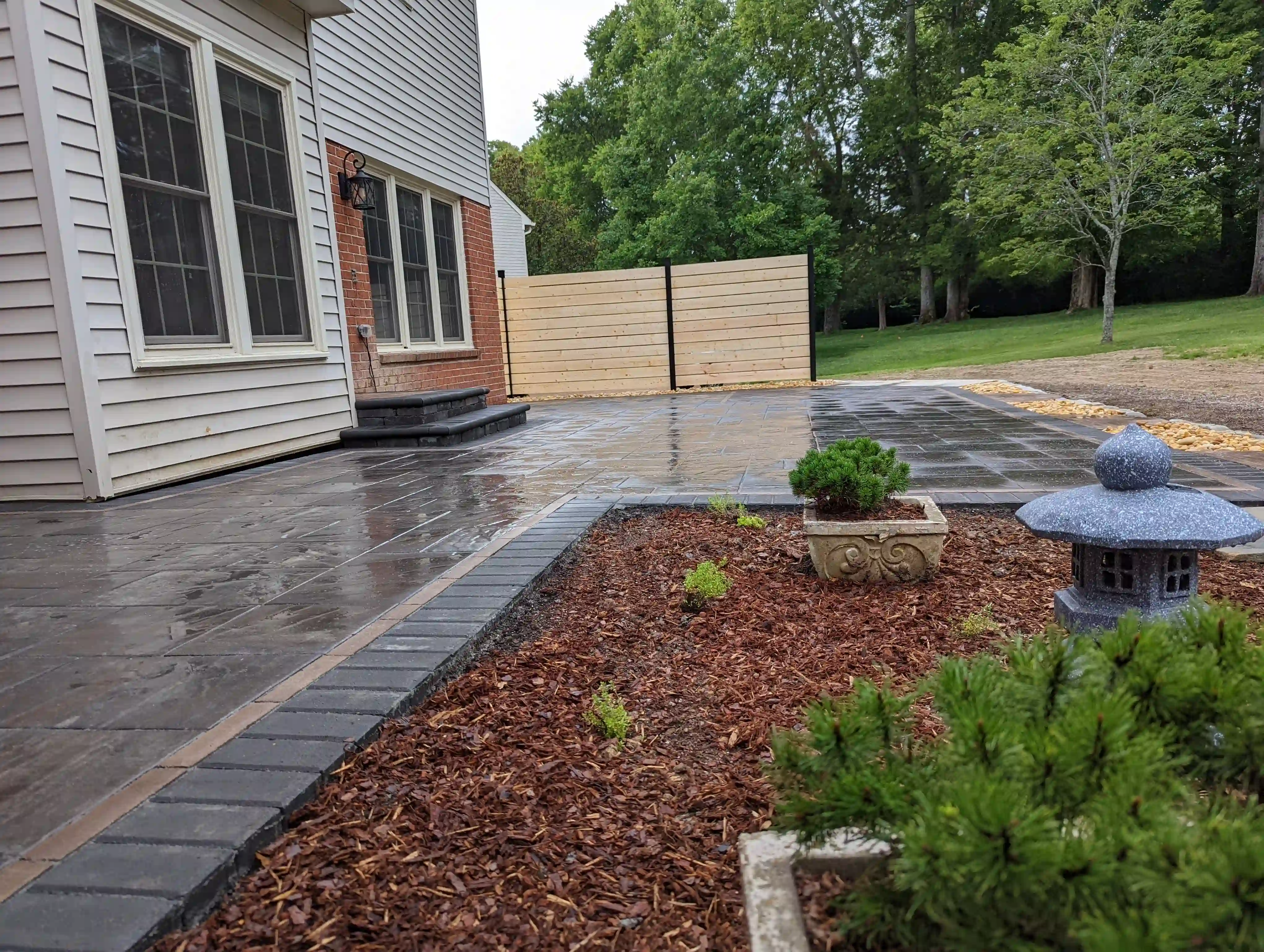 Mulched planting area with small green shrubs and wood chips