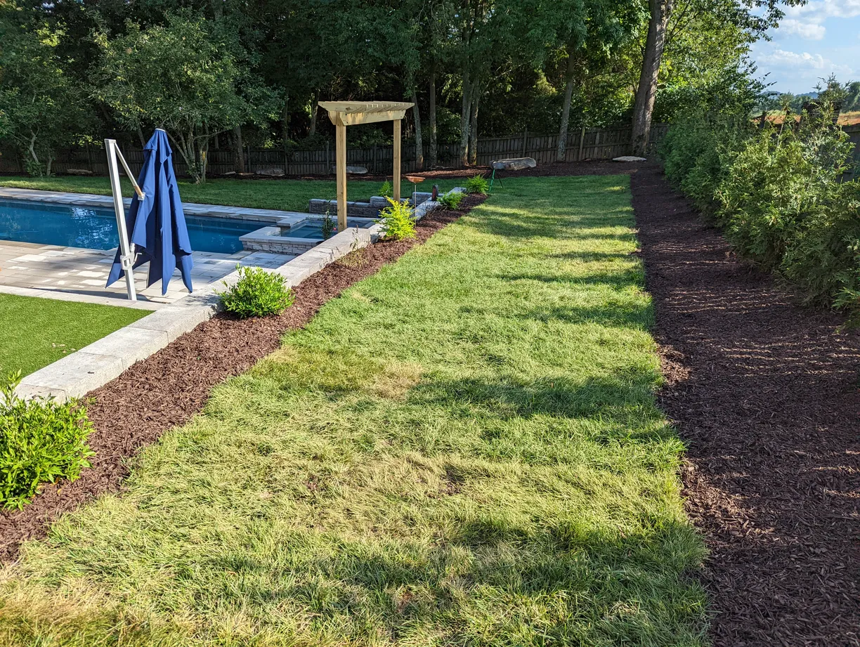 Landscape bed with fresh wood mulch and ornamental grasses