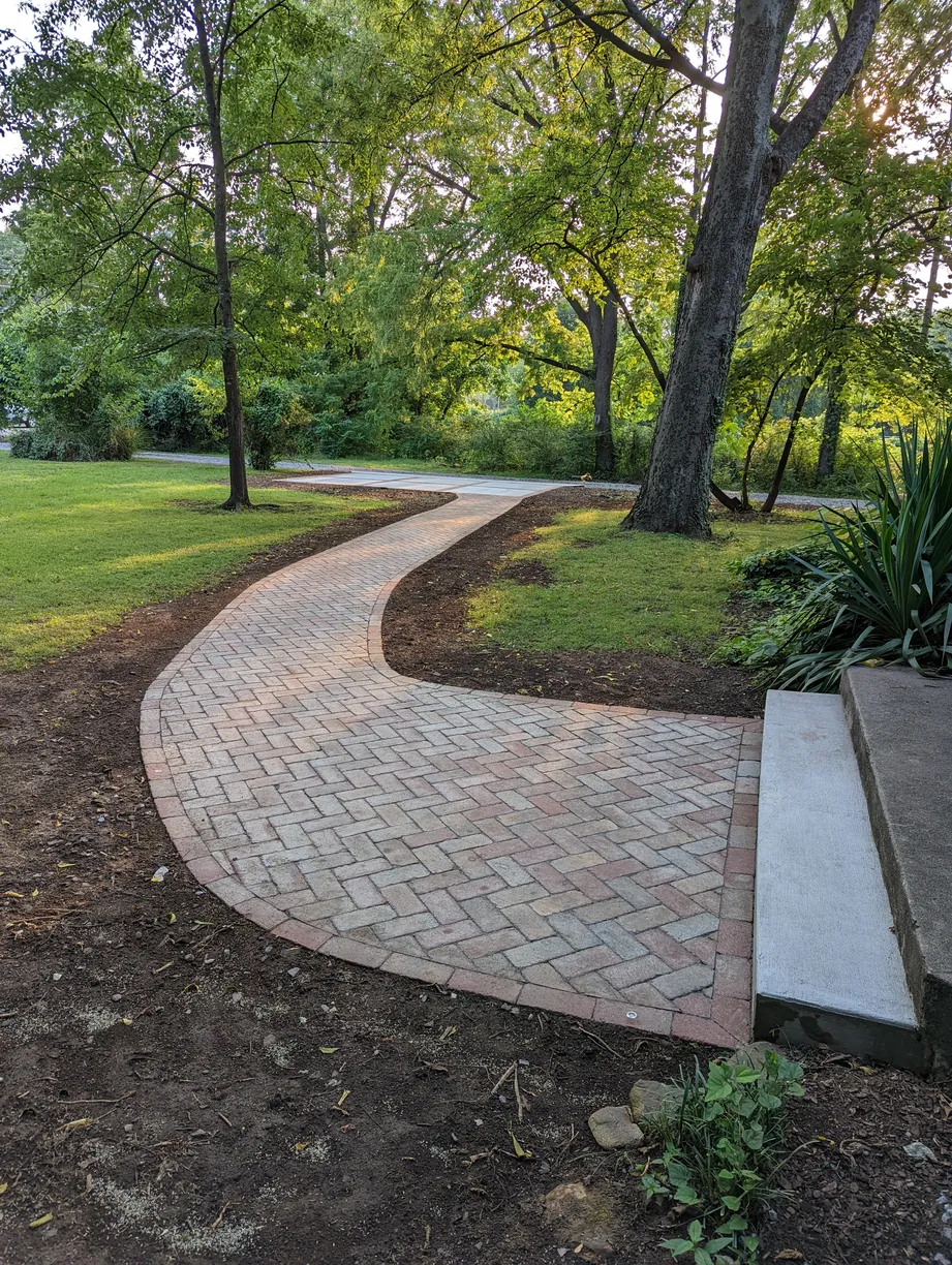 small red brick paver walkway to the driveway