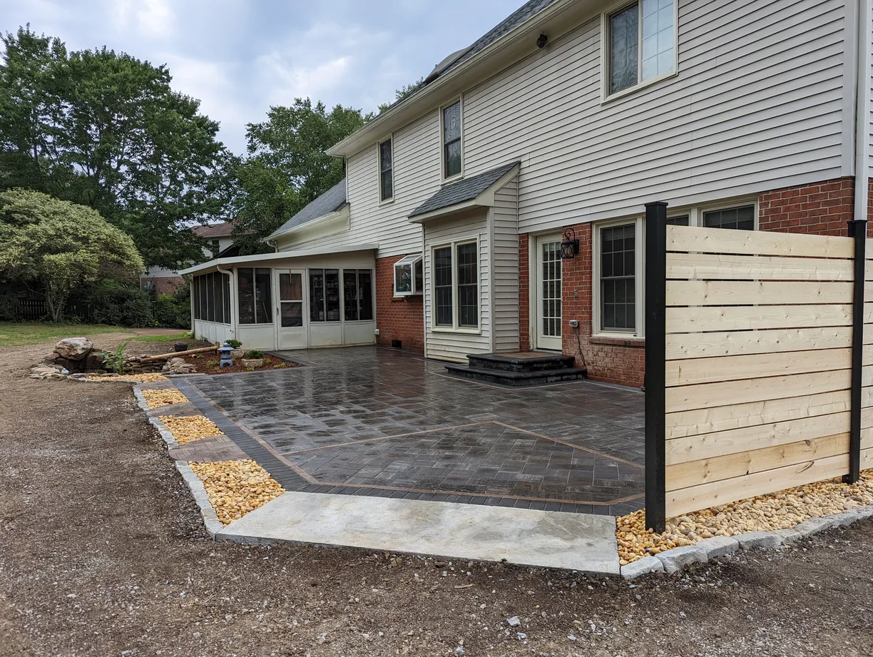 black paver patio directly out of the back door of a house