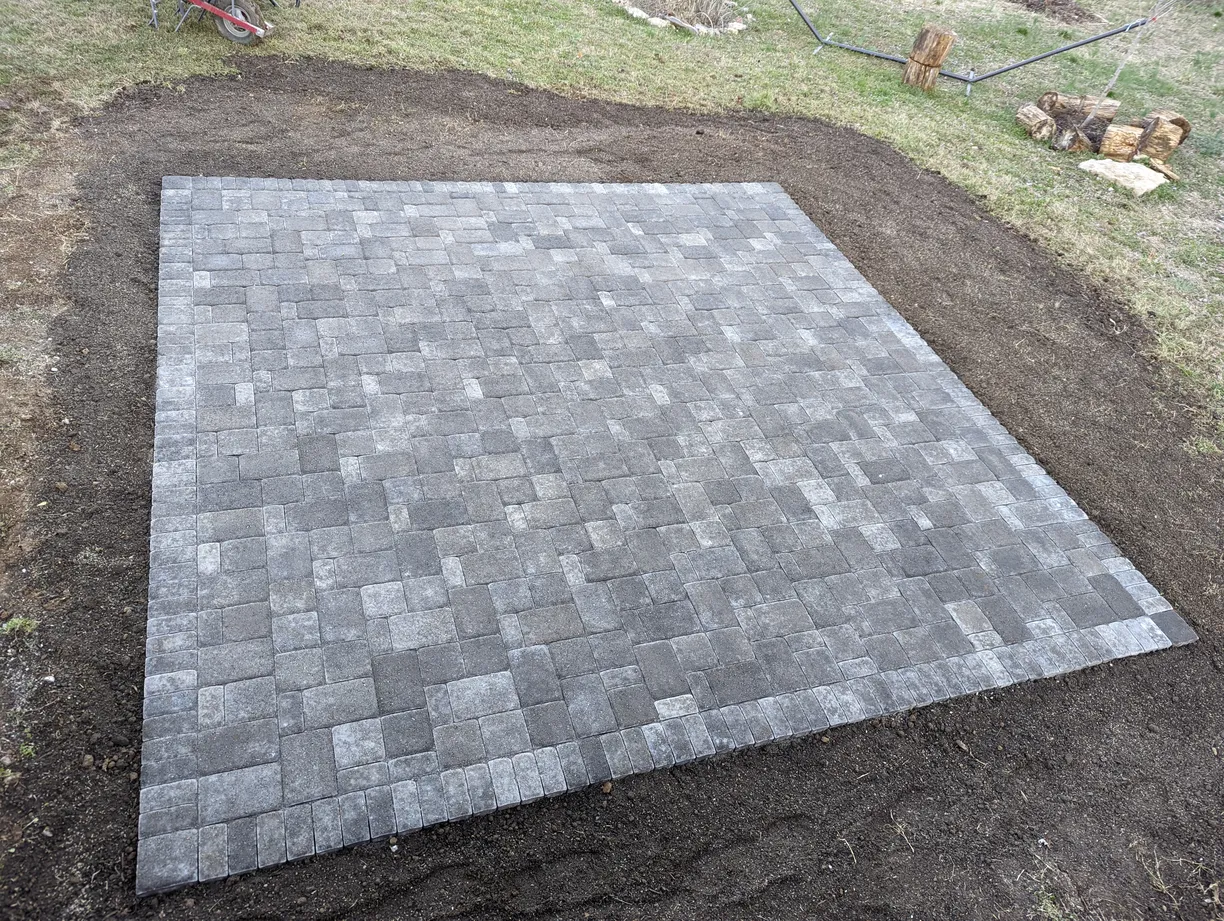 square patio made from pavers in a backyard