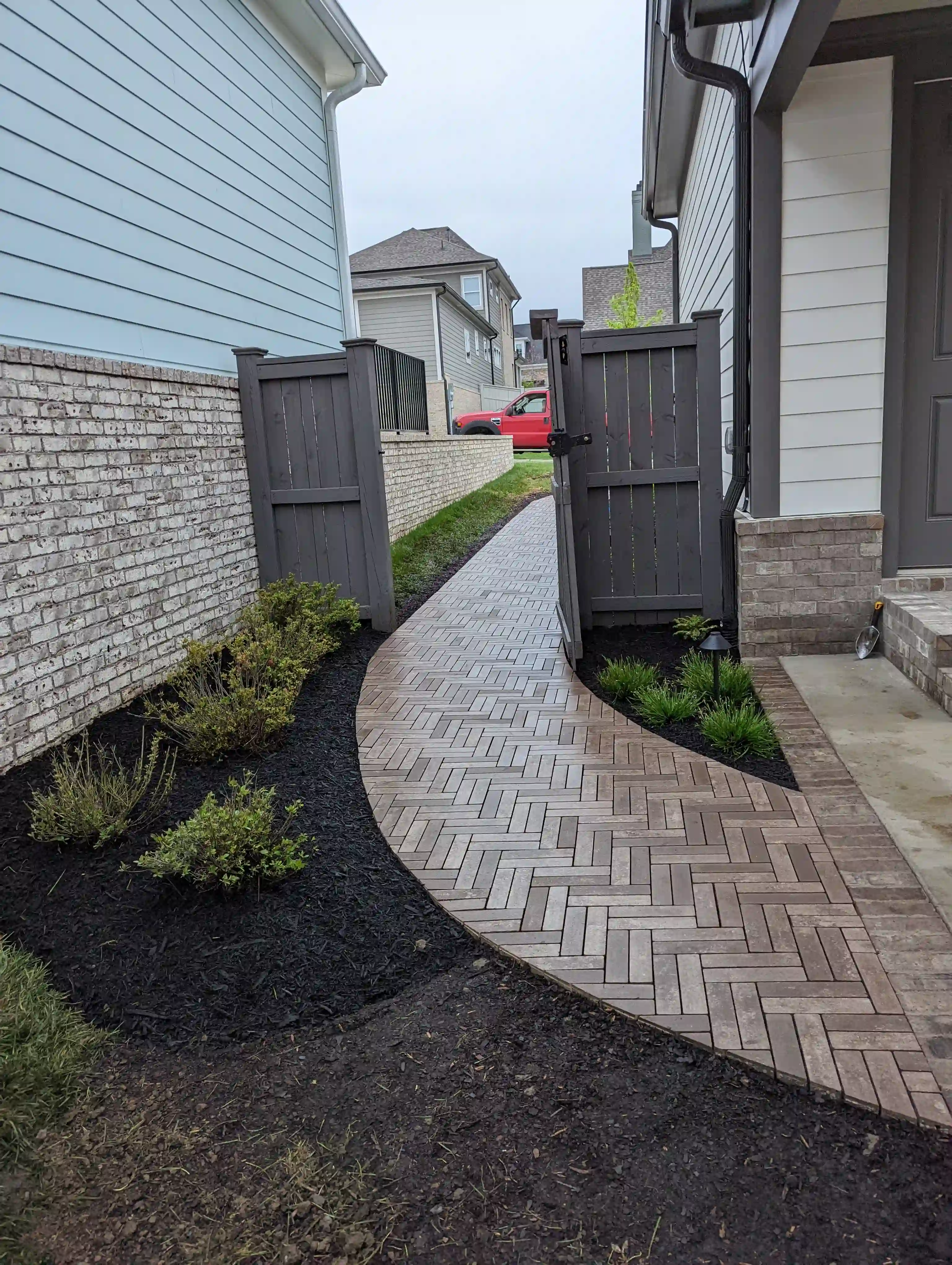 small red brick paver walway leading to the street