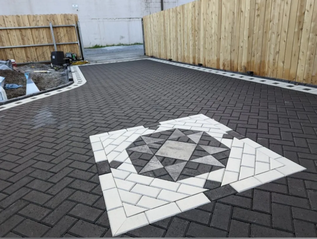 paver patio with a centerpiece star design made from differing colored paver stones
