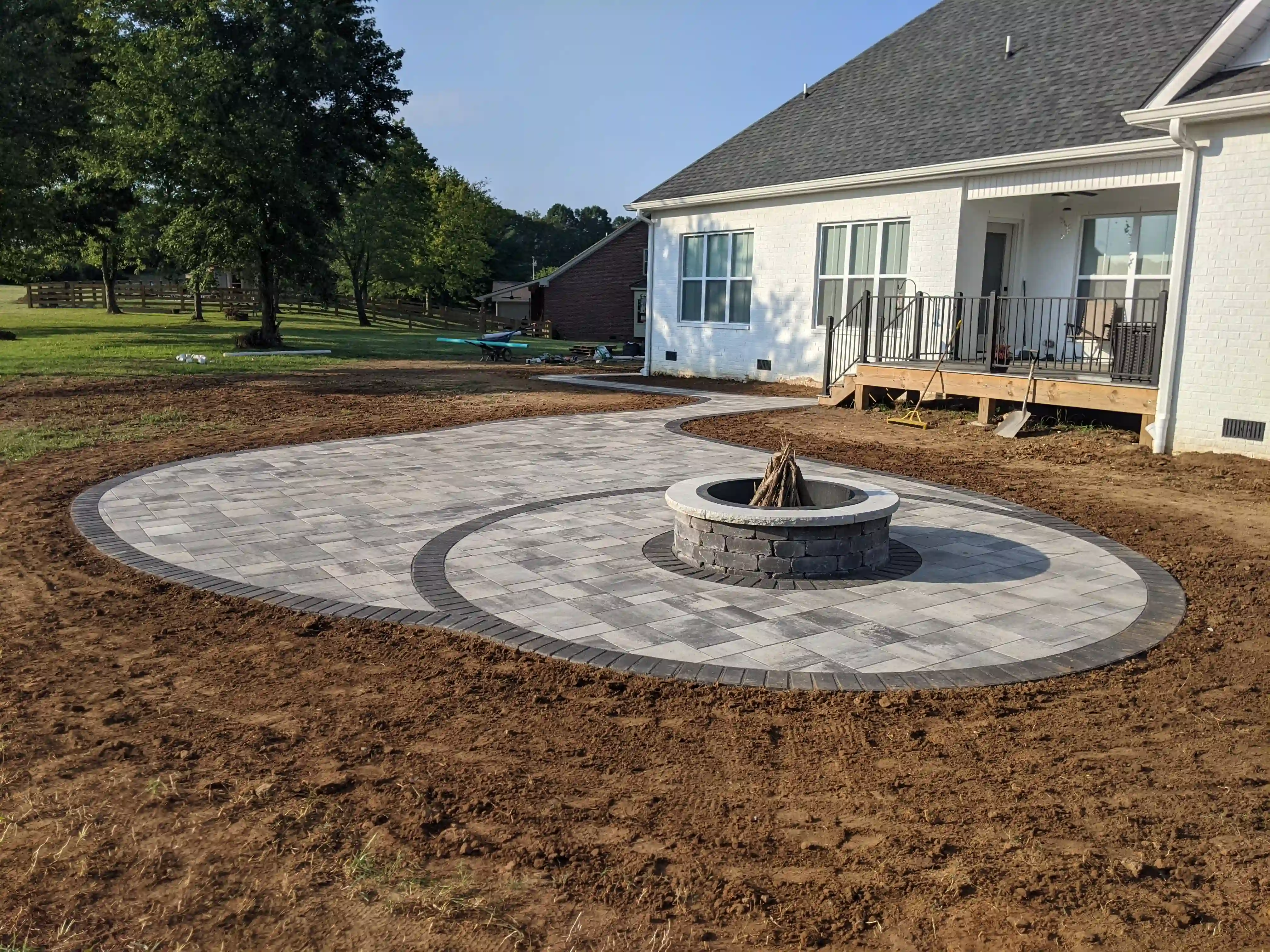 interestingly shaped paver patio with firepit in the middle