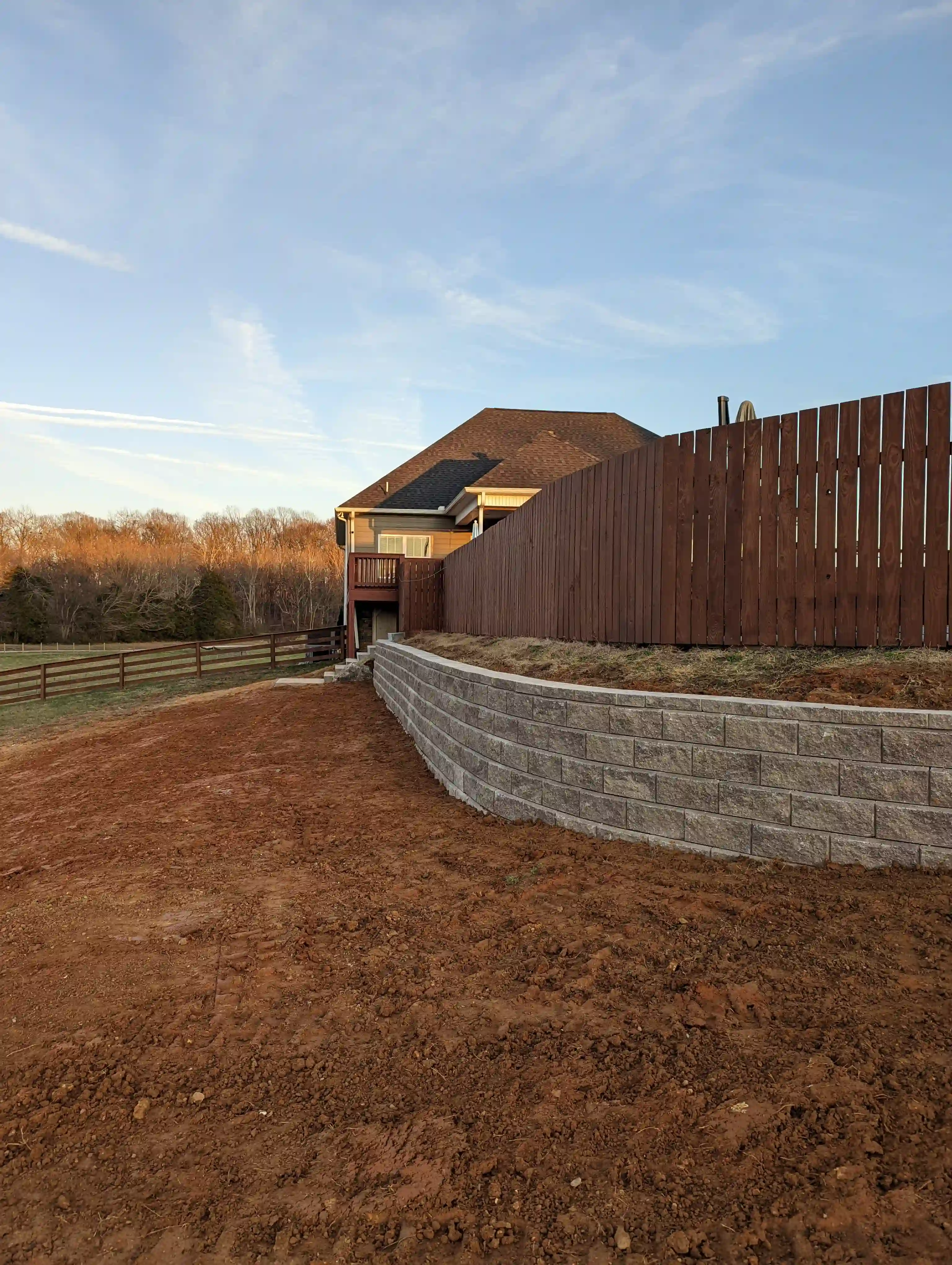 retaining wall installed to remove large sloped backyard