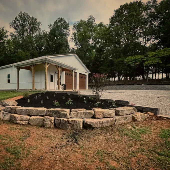 large stone retaining wall with garden bed