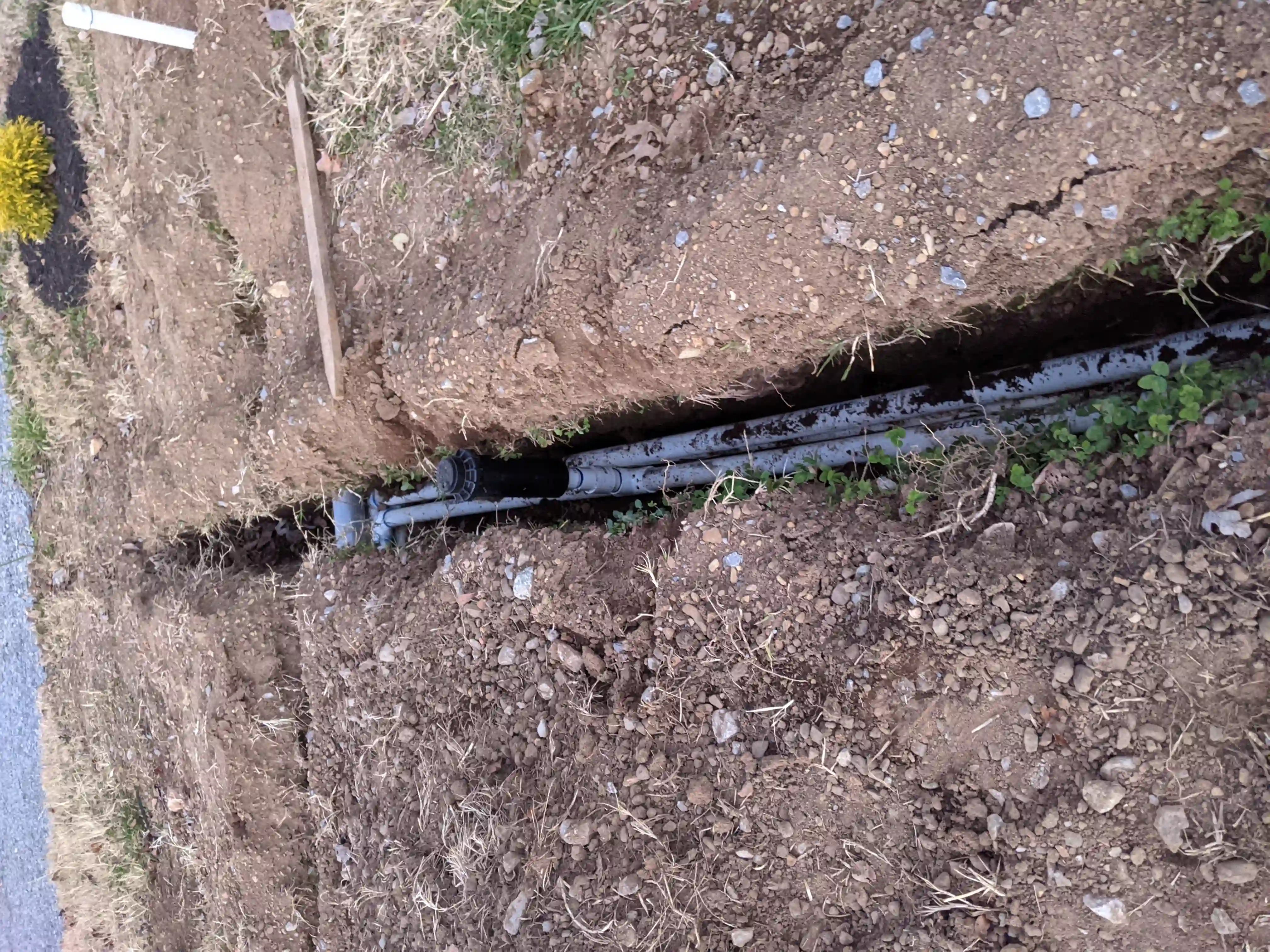 sprinkler inside trench with pvc piping 